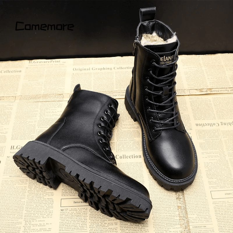 Black leather boots on a newspaper background