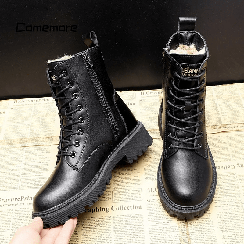 Black leather boots with fur lining on a newspaper background