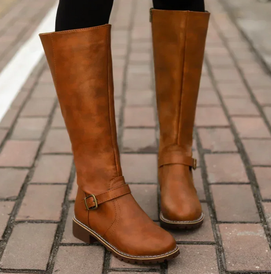 Brown knee-high boots on a paved surface