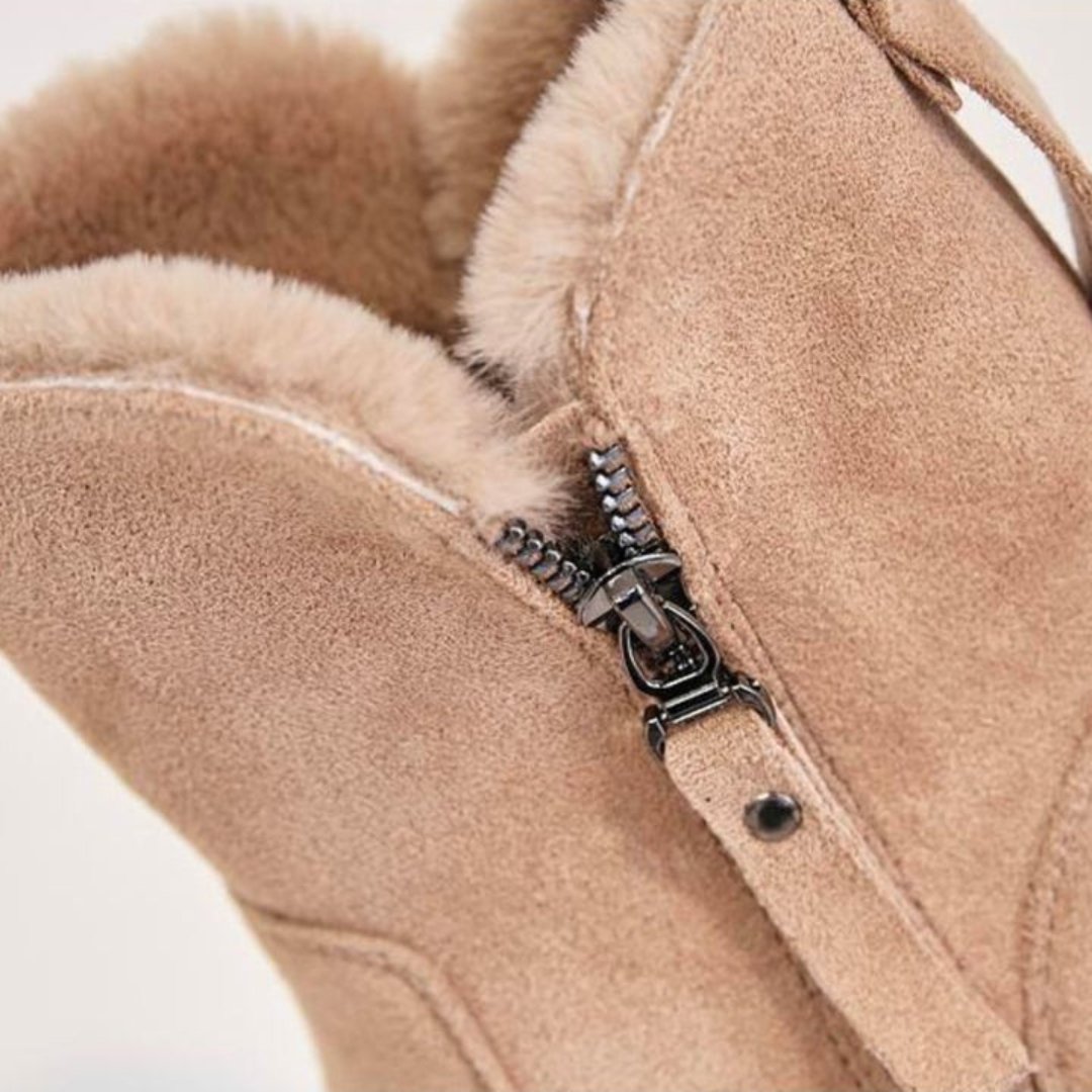 Close-up of a beige fleece jacket with a zipper detail on a white background