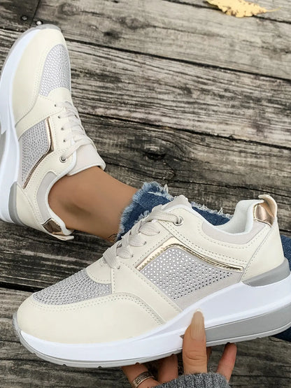 White sneakers with gray accents worn on a wooden surface